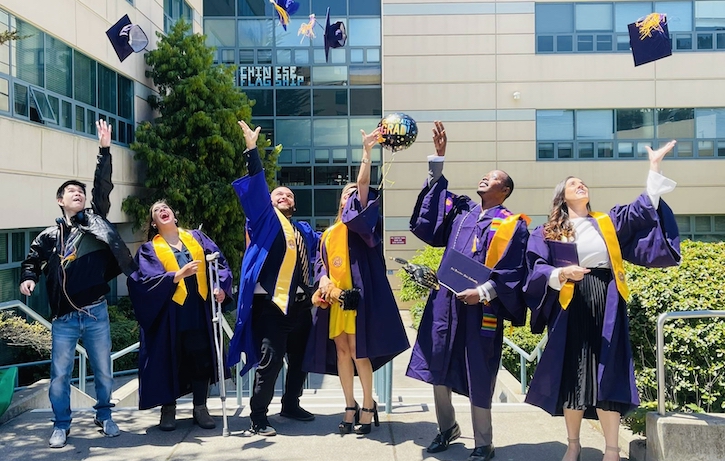 Graduates throwing their hat in the air